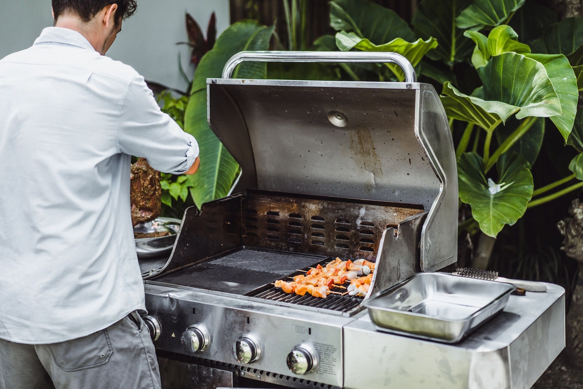 man tattoos makes barbecue grill meat outdoors 1
