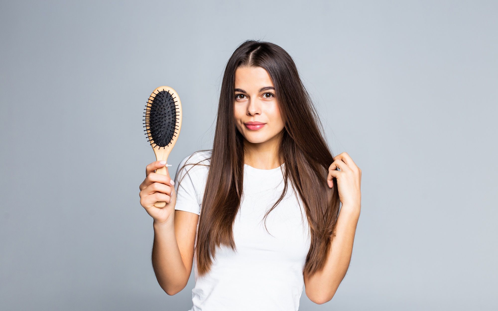 woman combing her hair isolated white