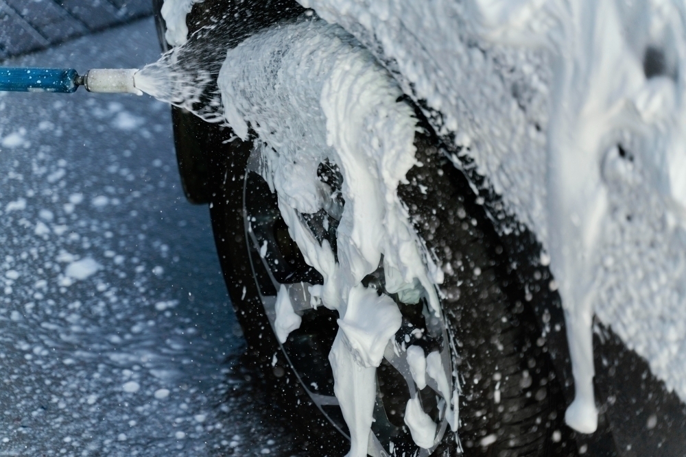 woman washing her car outdoors