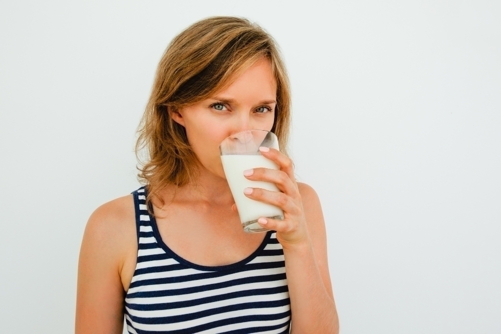 Attractive Young Woman Drinking Milk From Glass