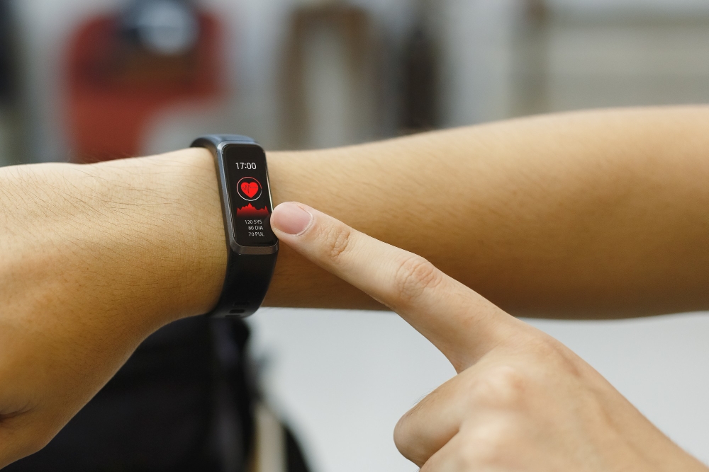 Close up hand of woman point finger at smart watch checking measuring heart rate after exercise