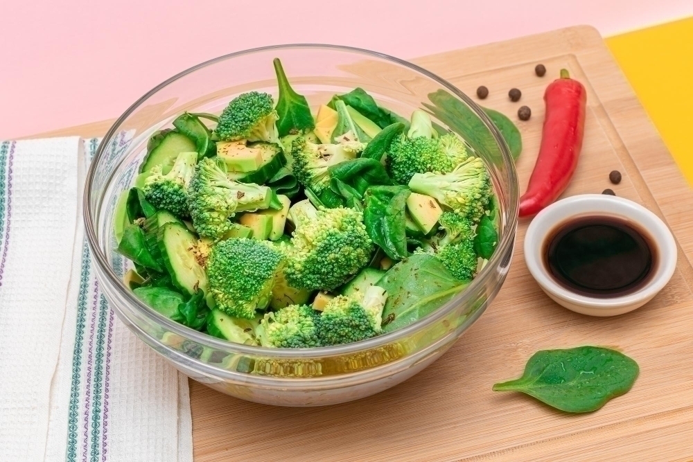 Fresh green salad of avocado broccoli spinach and cucumber