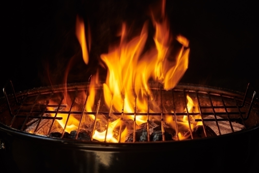 Grill Background. Barbecue Fire Grill close up isolated on Black Background
