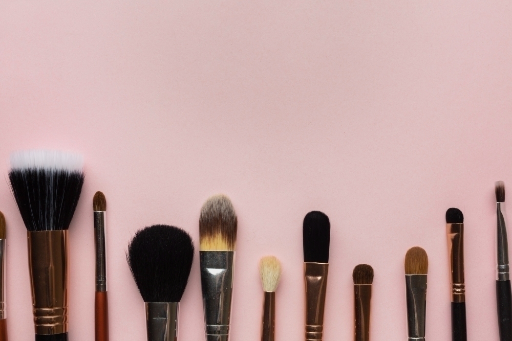 Top view frame with make up brushes and copy space