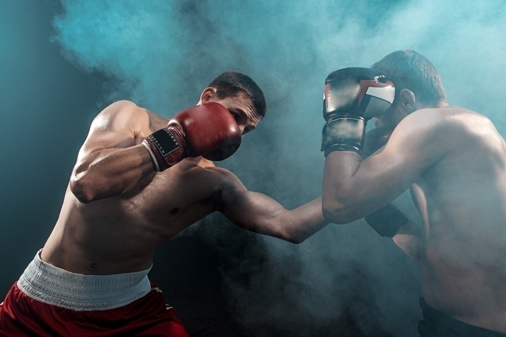 Two professional boxer boxing on black smoky space