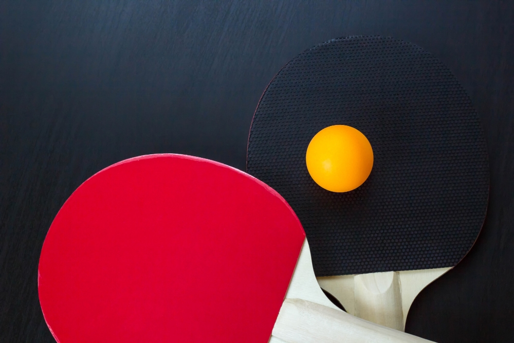 Two table tennis or ping pong rackets and ball