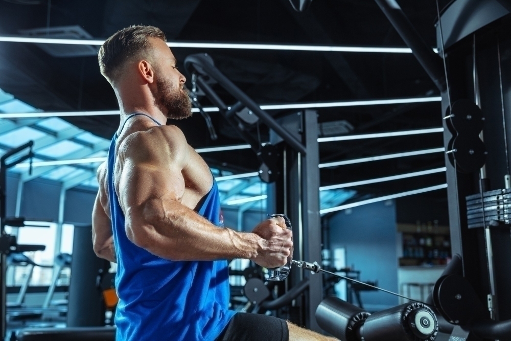 Young muscular caucasian athlete training in gym
