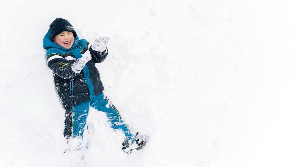 close up n happy kid playing snow