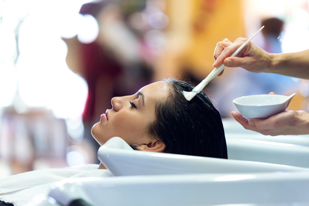 hairdresser applying hair treatment customer beauty salon